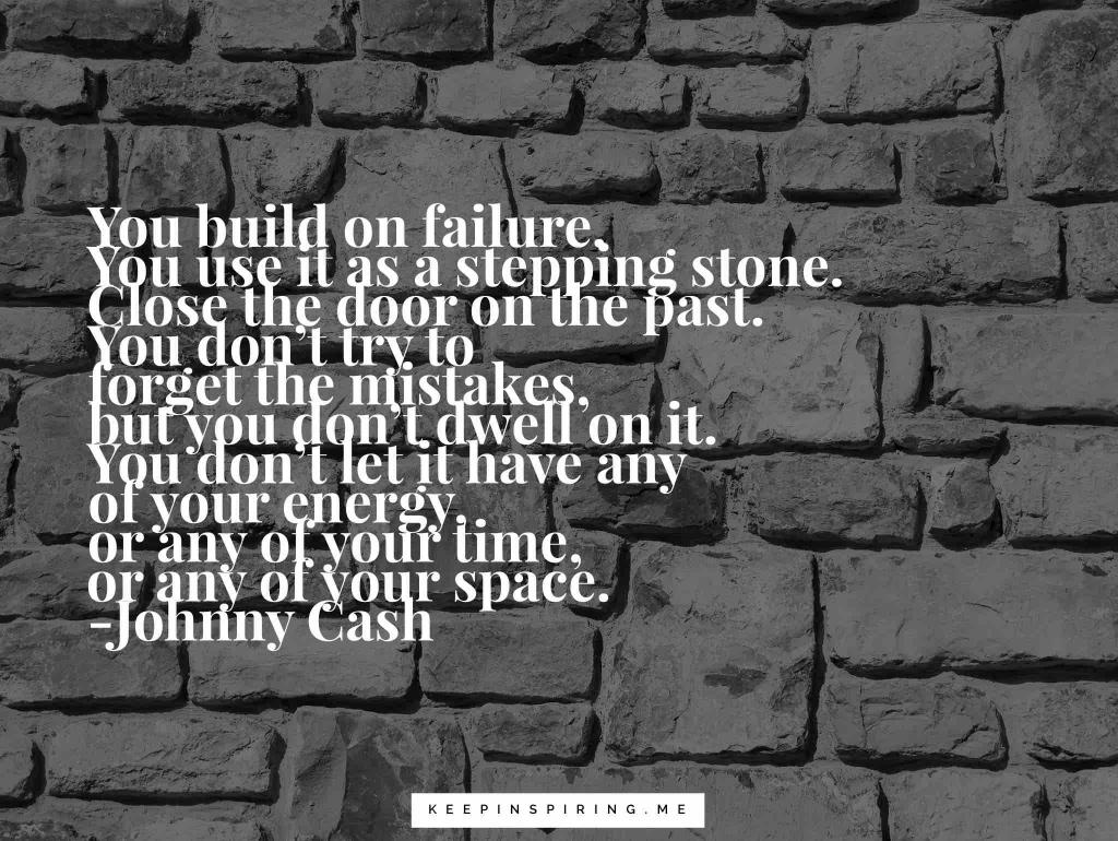 A dark gray stone wall with a Johnny Cash quote